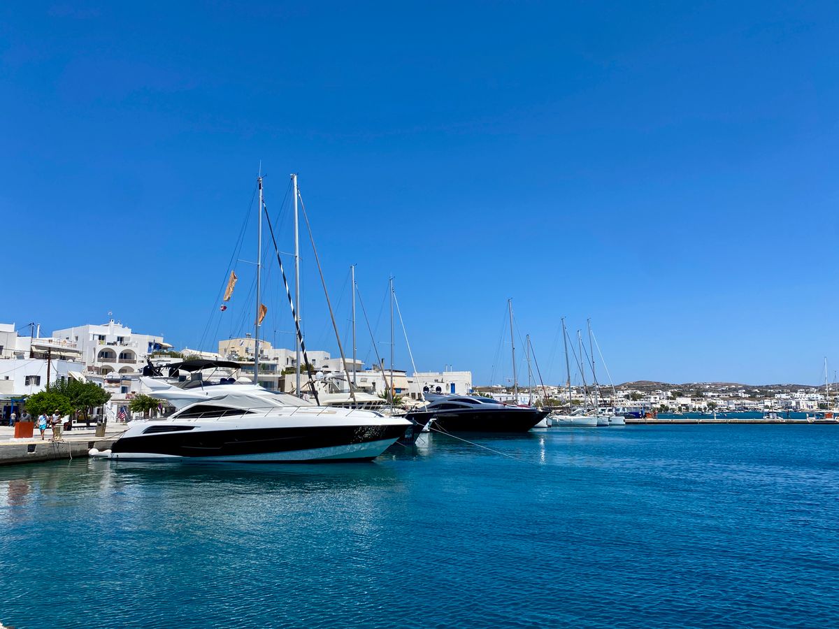 Sailing yachts moored in the harbour of Adamas, the main port town of Milos island