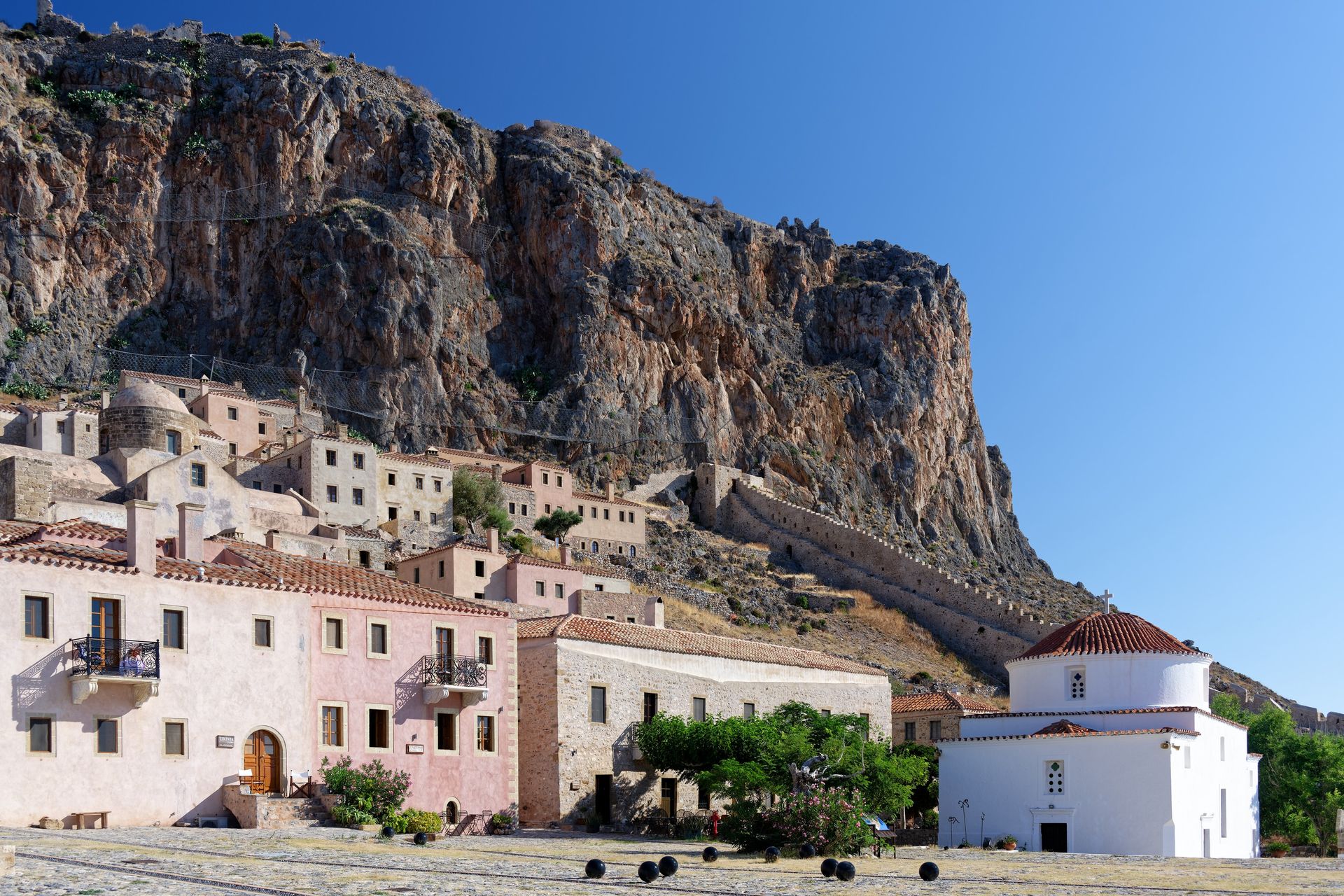 Medieval stone walls and cliffside architecture of Monemvasia fortress in southern Peloponnese