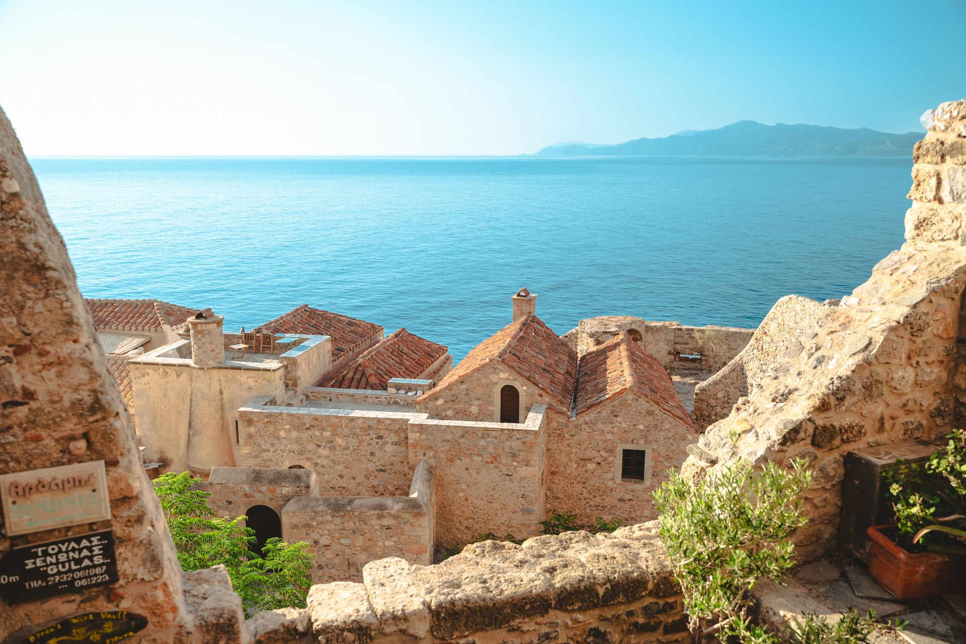Morning light on the medieval stone architecture of Monemvasia Lower Town overlooking the sea