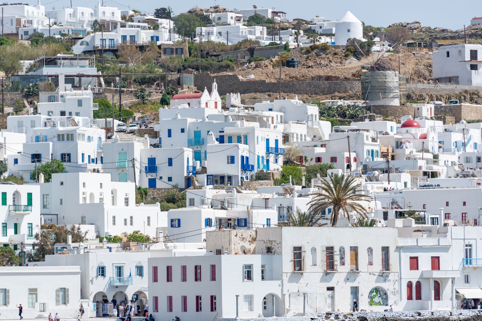Traditional white houses on a hillside in Mykonos, Greece, overlooking the harbour