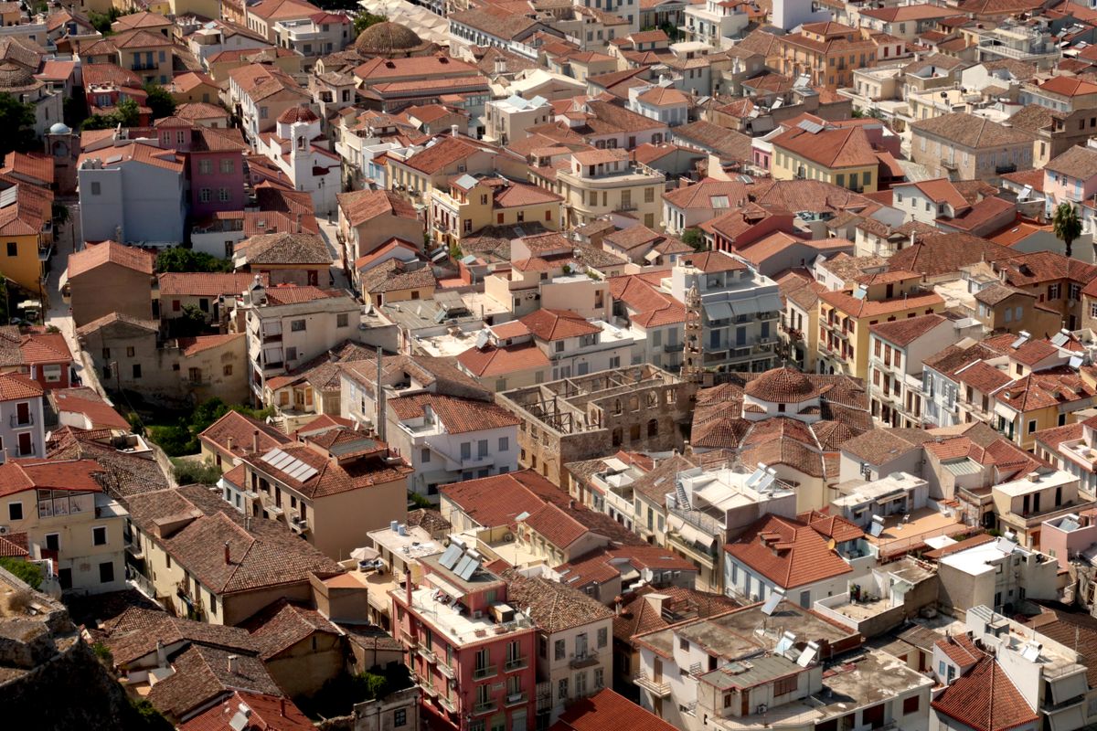 Red-tiled rooftops of Nafplio old town with the Argolic Gulf visible beyond