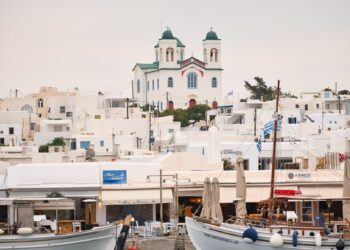 The old fishing port of Naoussa in Paros with traditional boats and waterfront buildings