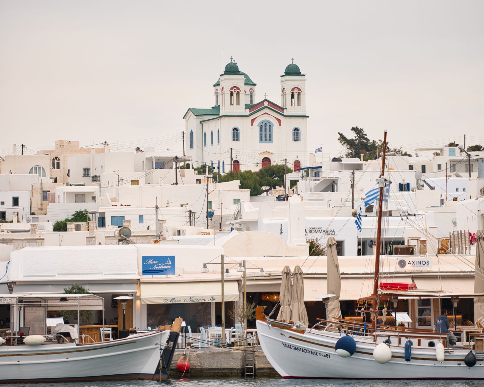 The old fishing port of Naoussa in Paros with traditional boats and waterfront buildings