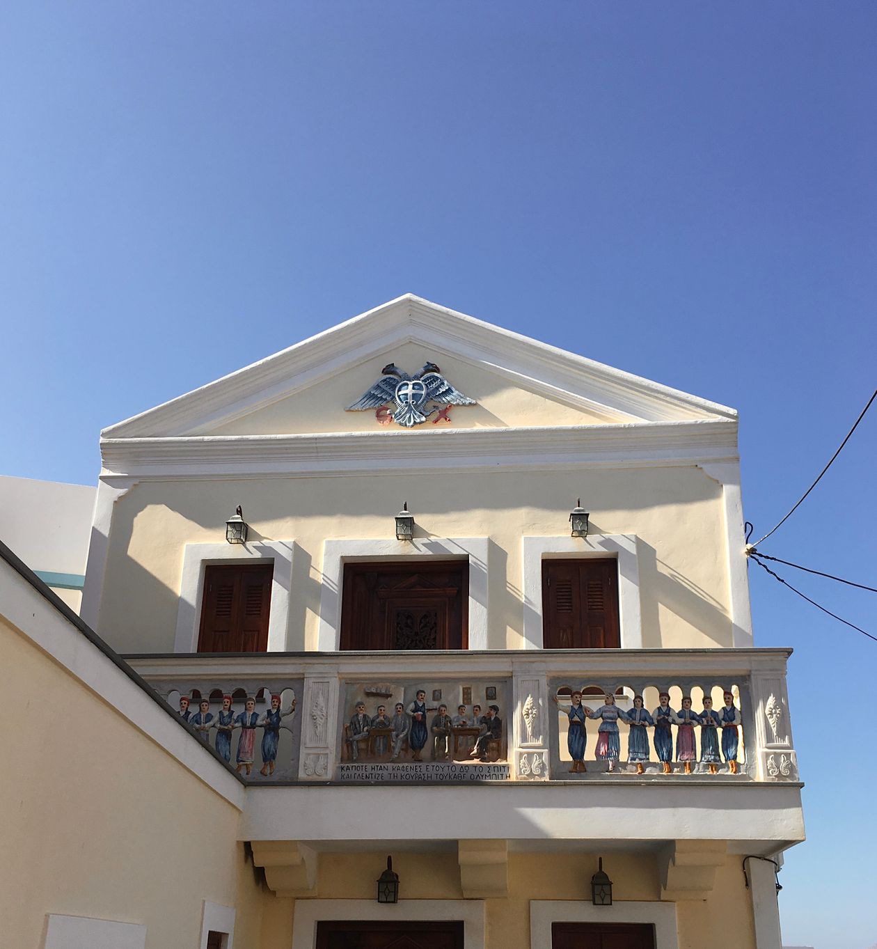 Neoclassical building with painted balcony frescoes in Ermoupoli, Syros