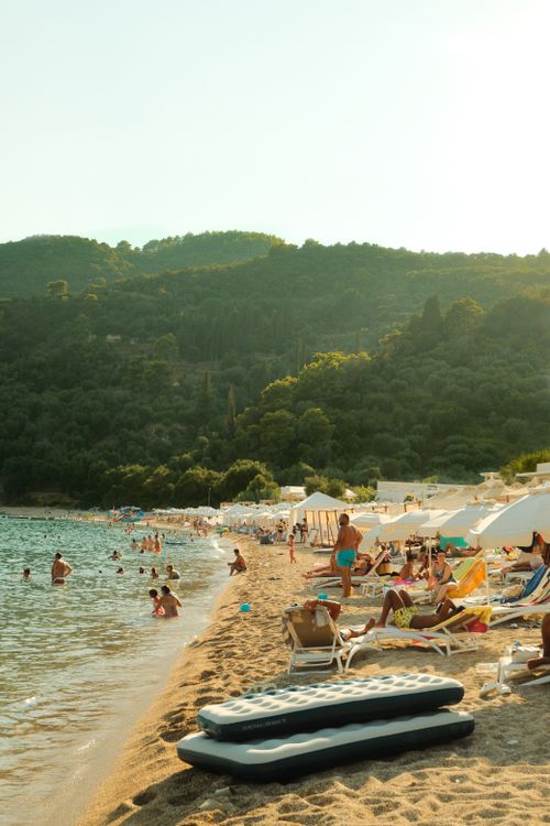 Beach with umbrellas and clear water in Parga, Greece