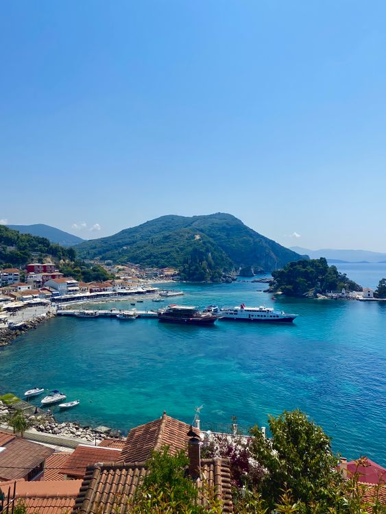 Parga harbour with colourful waterfront buildings and moored boats in Epirus, Greece
