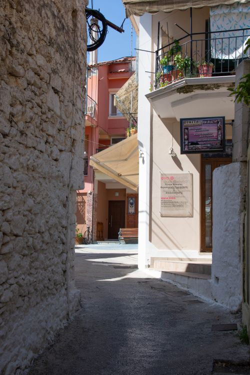 Narrow alley between colourful buildings in Parga old town, Epirus