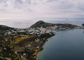 Aerial view of Patmos island coastline with traditional white buildings and blue Aegean Sea