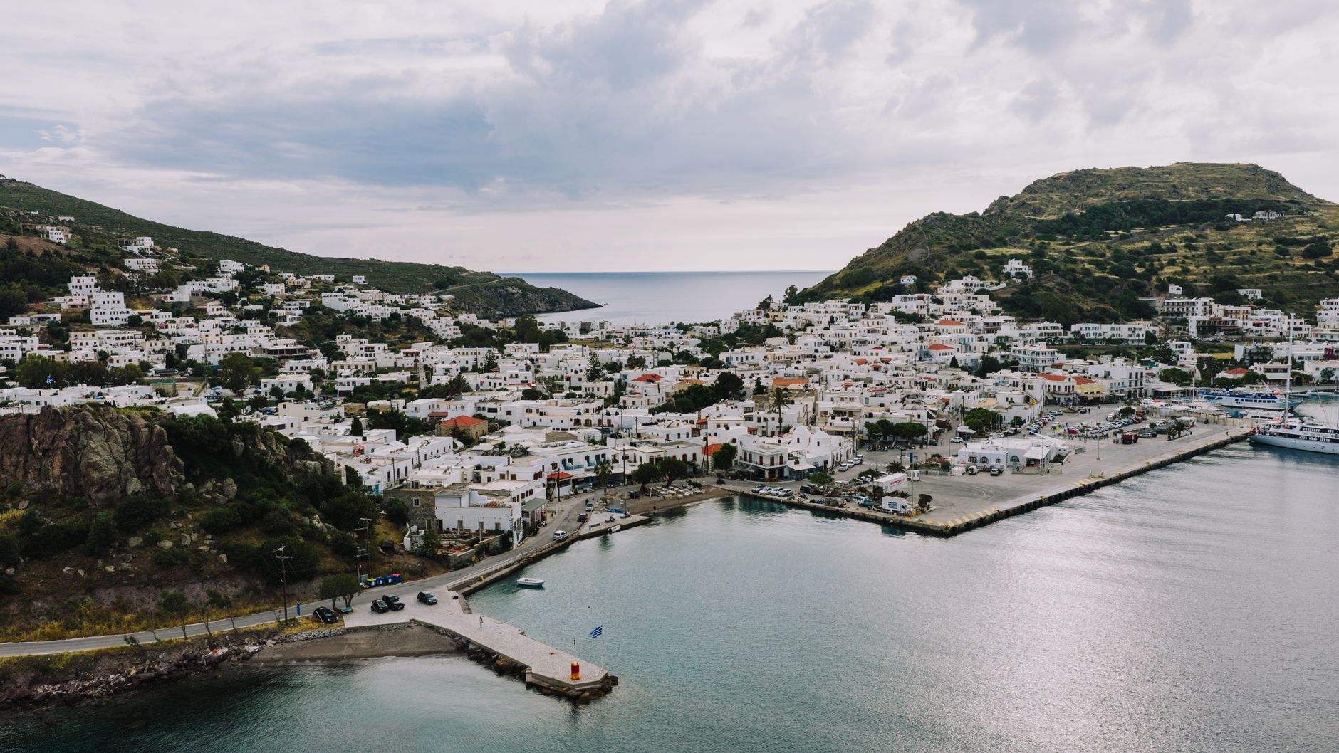 Skala harbour Patmos with whitewashed buildings and sailing boats