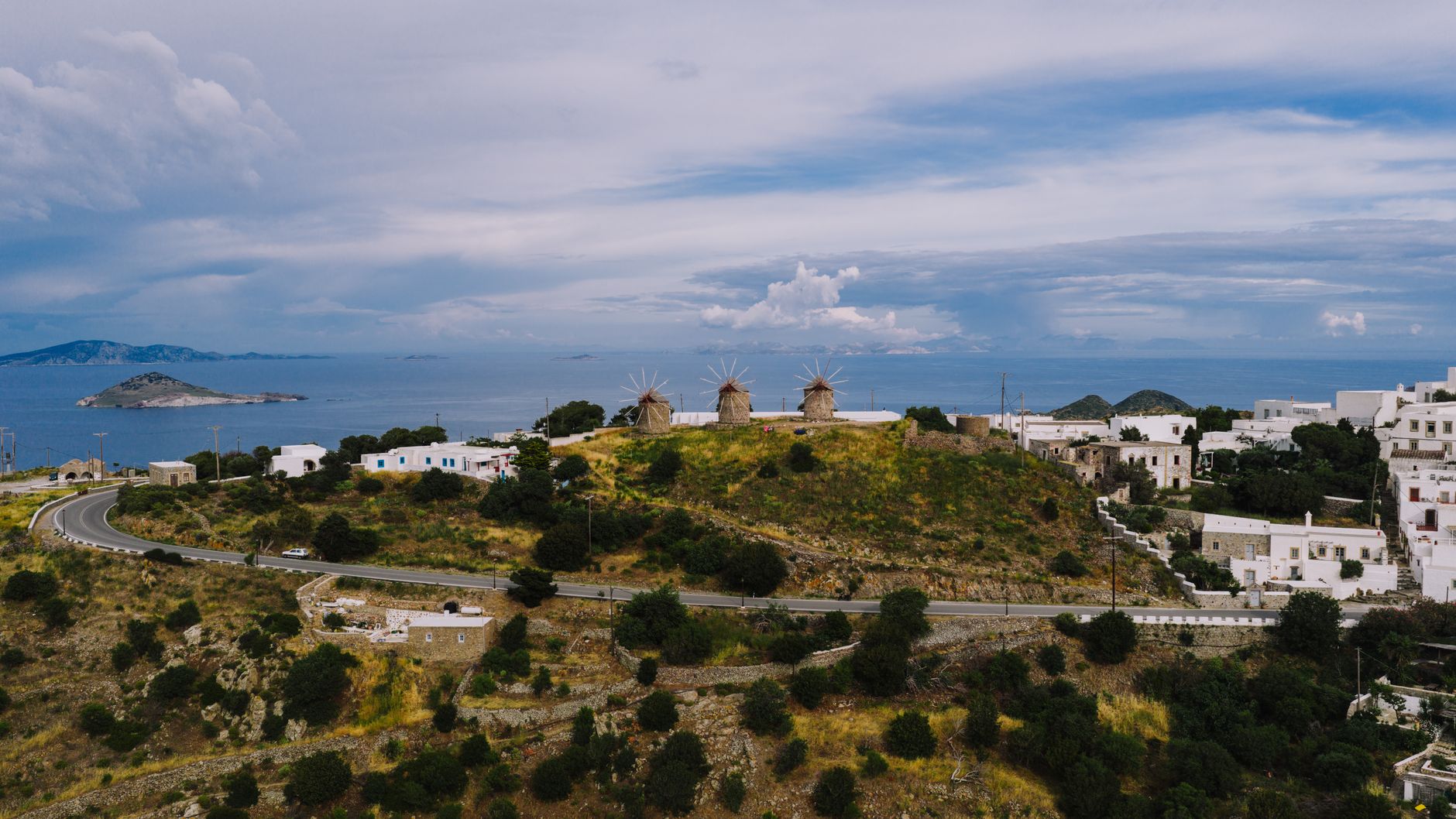 Historic windmills on Patmos island with Aegean Sea backdrop