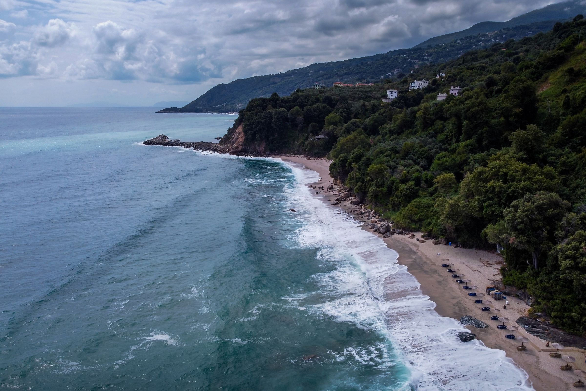 Aerial view of Pelion coastline where dense forest meets the Aegean Sea