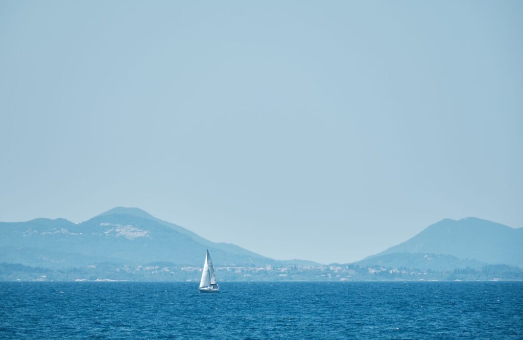 Sailboat near Perdika village, Aegina, with mountains in the background
