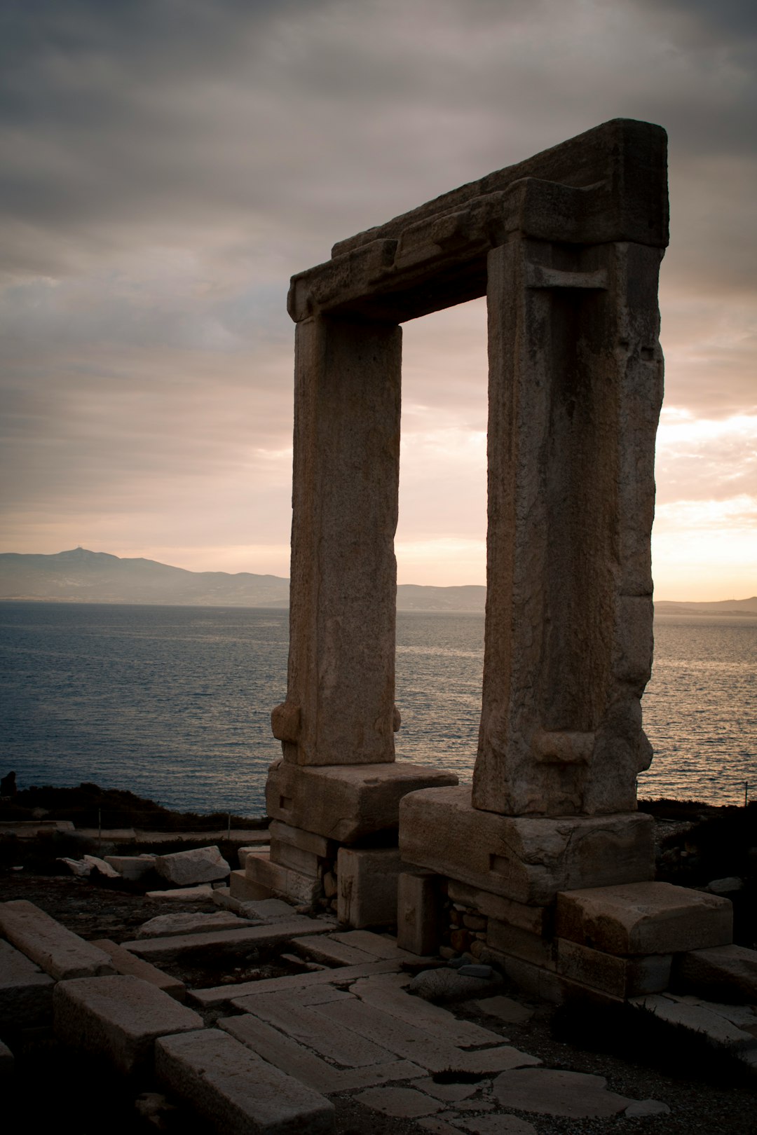 The marble Portara of the unfinished Temple of Apollo overlooking the sea at sunset in Naxos
