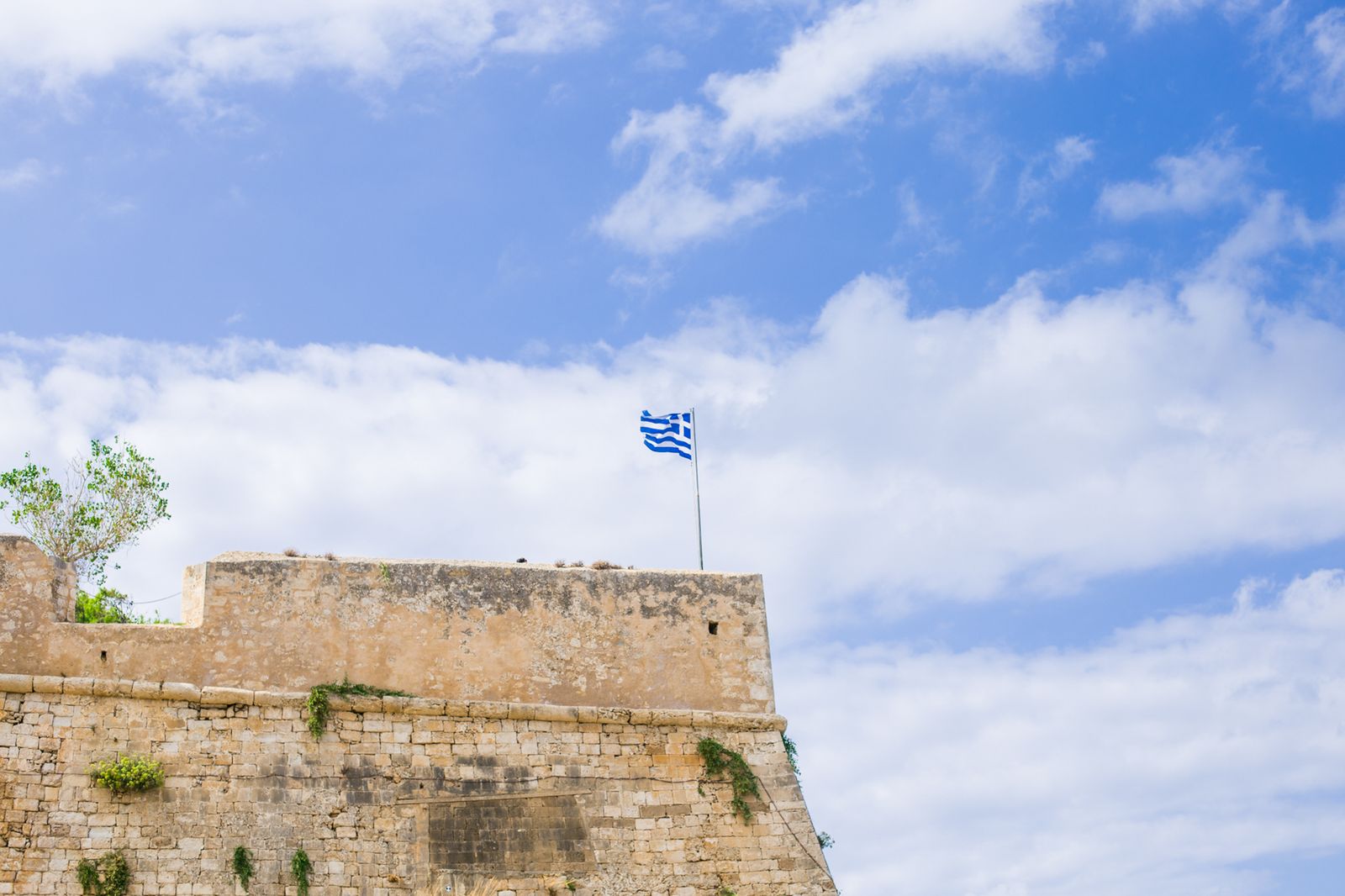Greek flag flying above the stone ramparts of the Fortezza, the Venetian fortress overlooking Rethymno