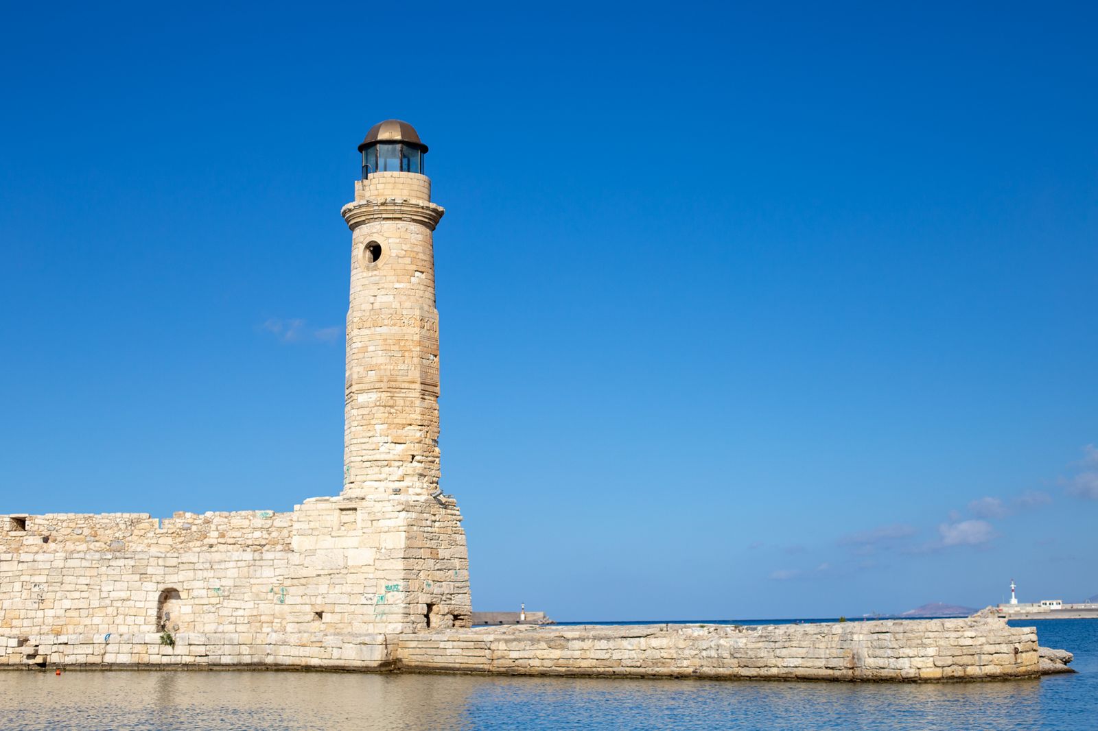 The Egyptian-built lighthouse at the end of the Venetian harbour breakwater in Rethymno under clear skies