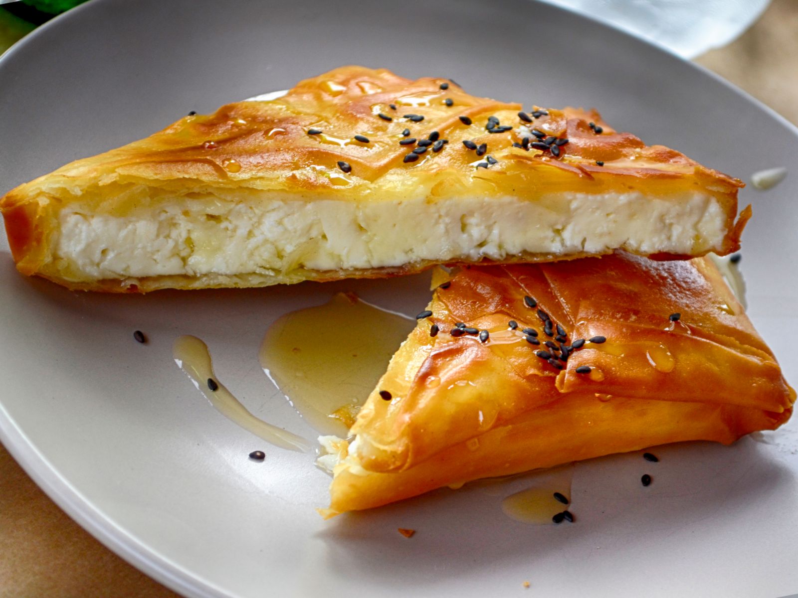 Sfakiani pita-style Cretan cheese pie drizzled with honey and sesame