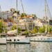Yachts and sailboats moored in Skiathos harbour with the town rising behind