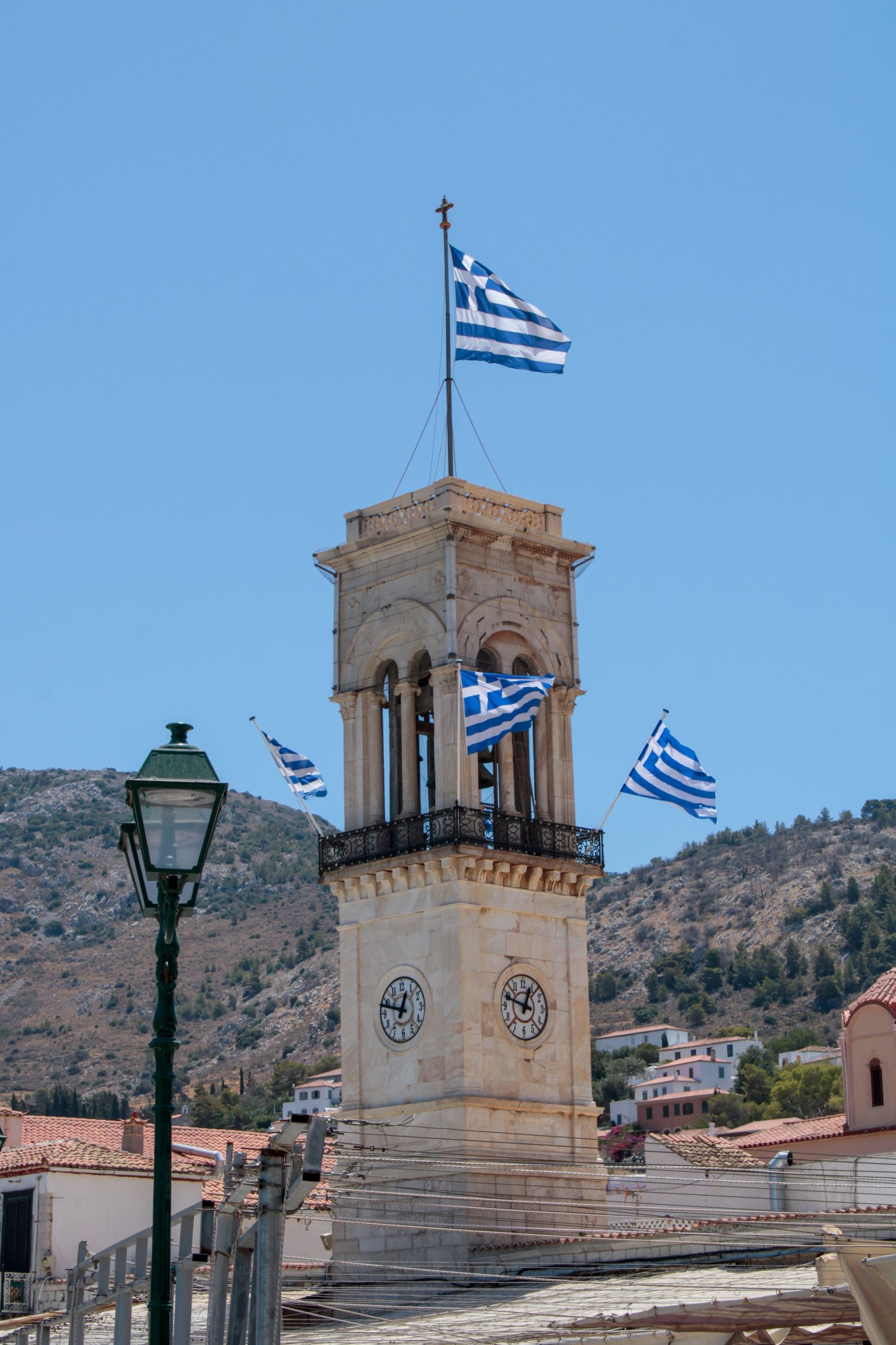 Clock tower adorned with Greek flags in Spetses town centre