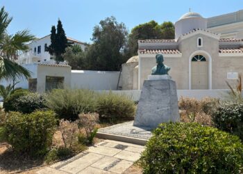 Bronze memorial bust in front of an Orthodox church in Spetses town Greece