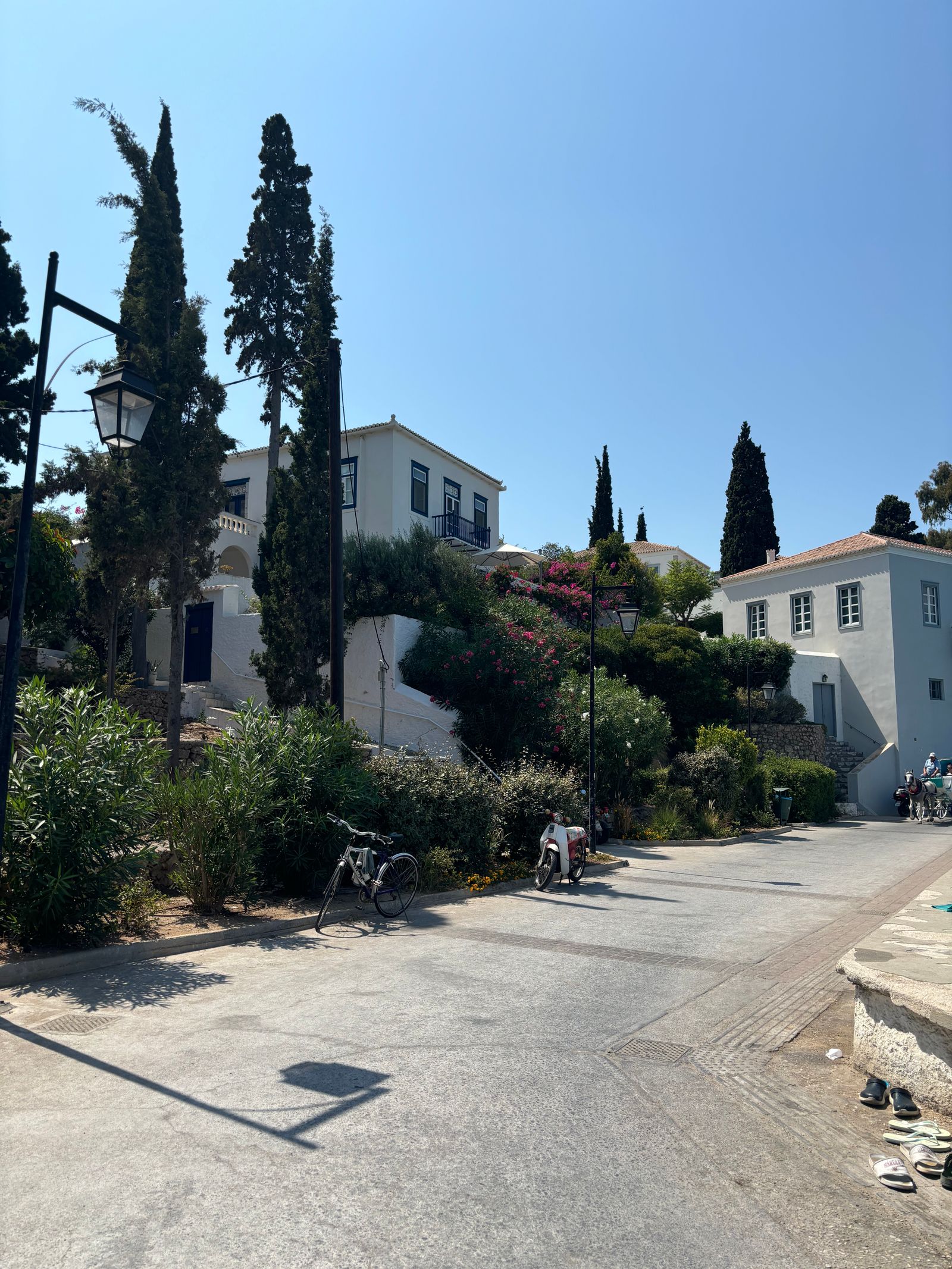 Traditional Spetses street with neoclassical architecture and lush greenery in summer