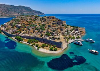 Aerial view of Spinalonga island fortress surrounded by blue sea near Elounda, eastern Crete