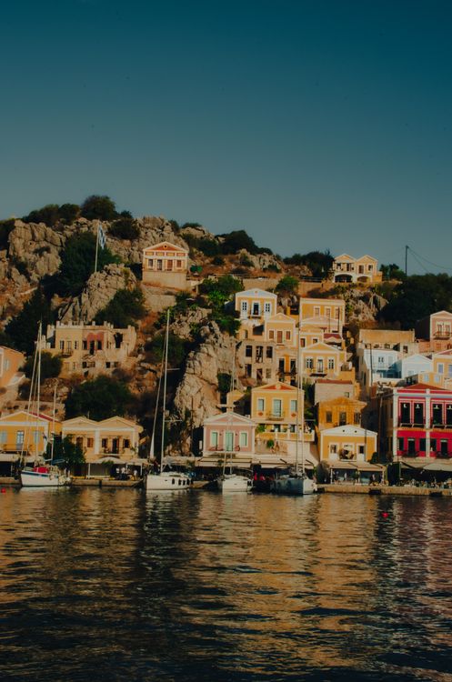 Colourful houses lining the waterfront of Gialos, the main harbour of Symi Island, Greece