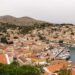 Aerial view of Symi island harbour with colourful neoclassical houses rising up the hillside, Dodecanese, Greece