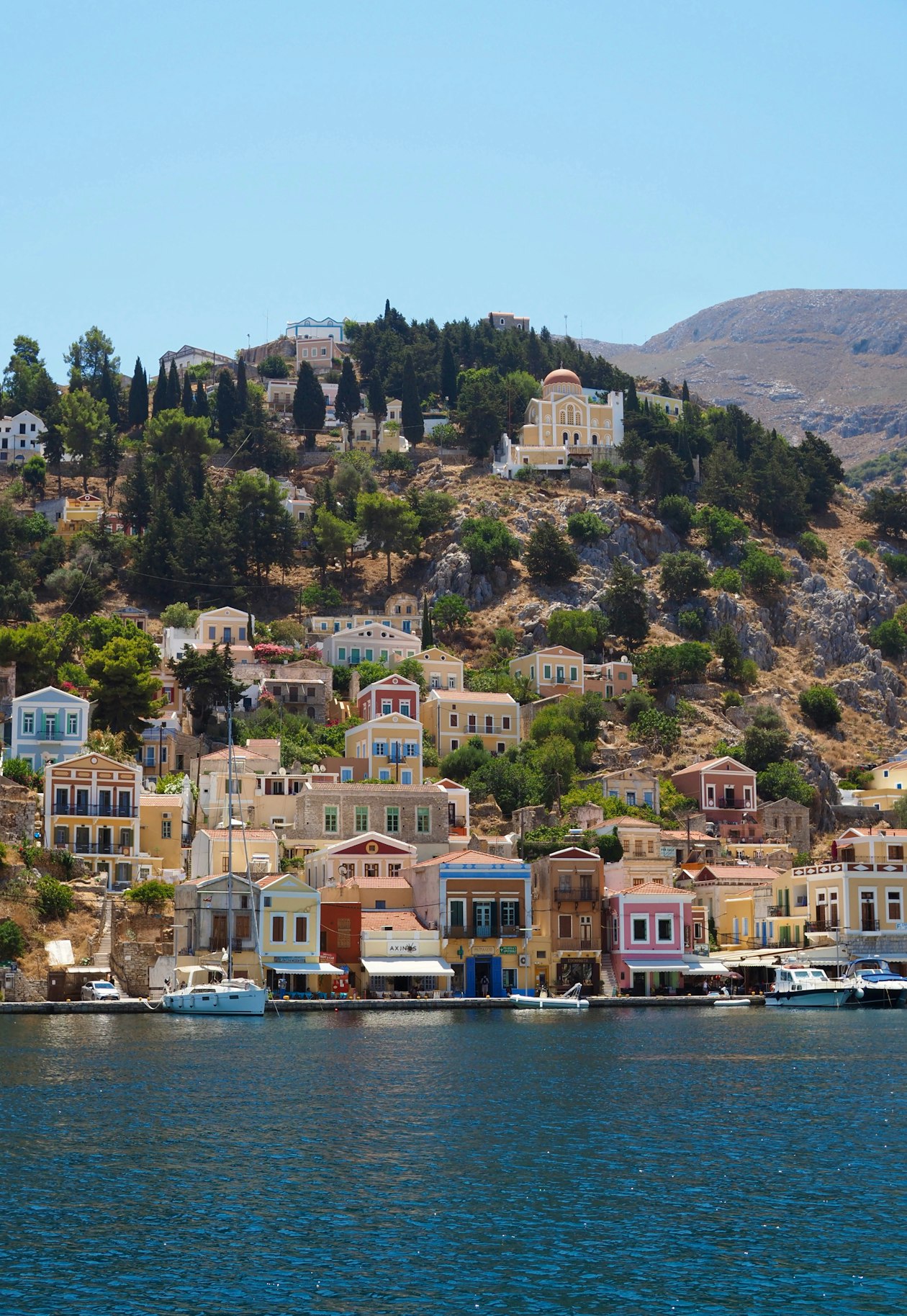 Symi town houses on the mountainside above the harbour, Dodecanese, Greece