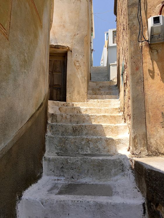 Narrow stone alleyway with steps on Symi Island, Dodecanese, Greece
