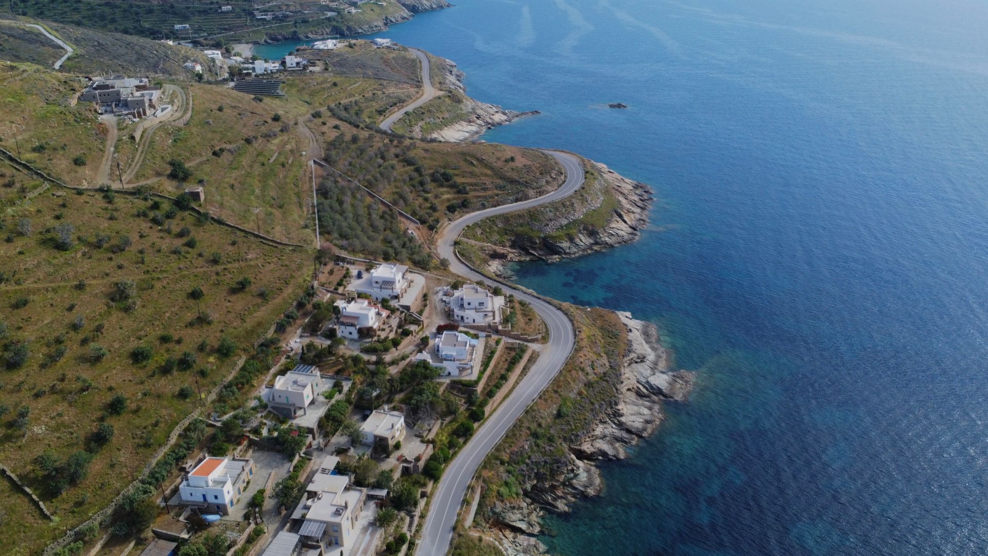 Aerial view of a winding coastal road on the eastern shore of Syros