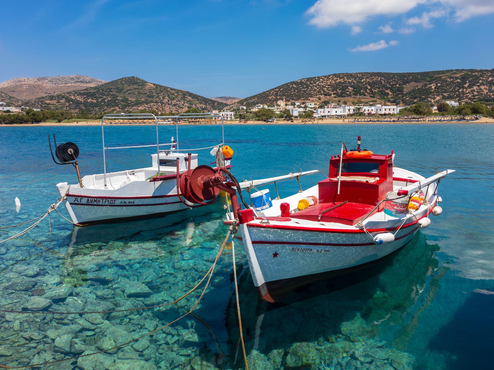Traditional Greek fishing boats in a sheltered bay on Syros island