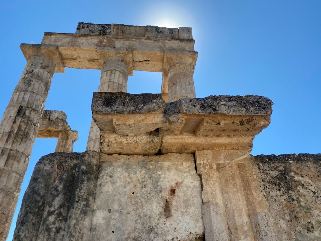 Sunlit ancient Greek columns at the Temple of Aphaia, Aegina Island