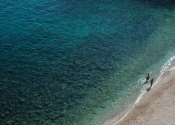 Clear turquoise waters and sandy shore at a beach on Thasos island Greece