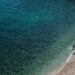 Clear turquoise waters and sandy shore at a beach on Thasos island Greece