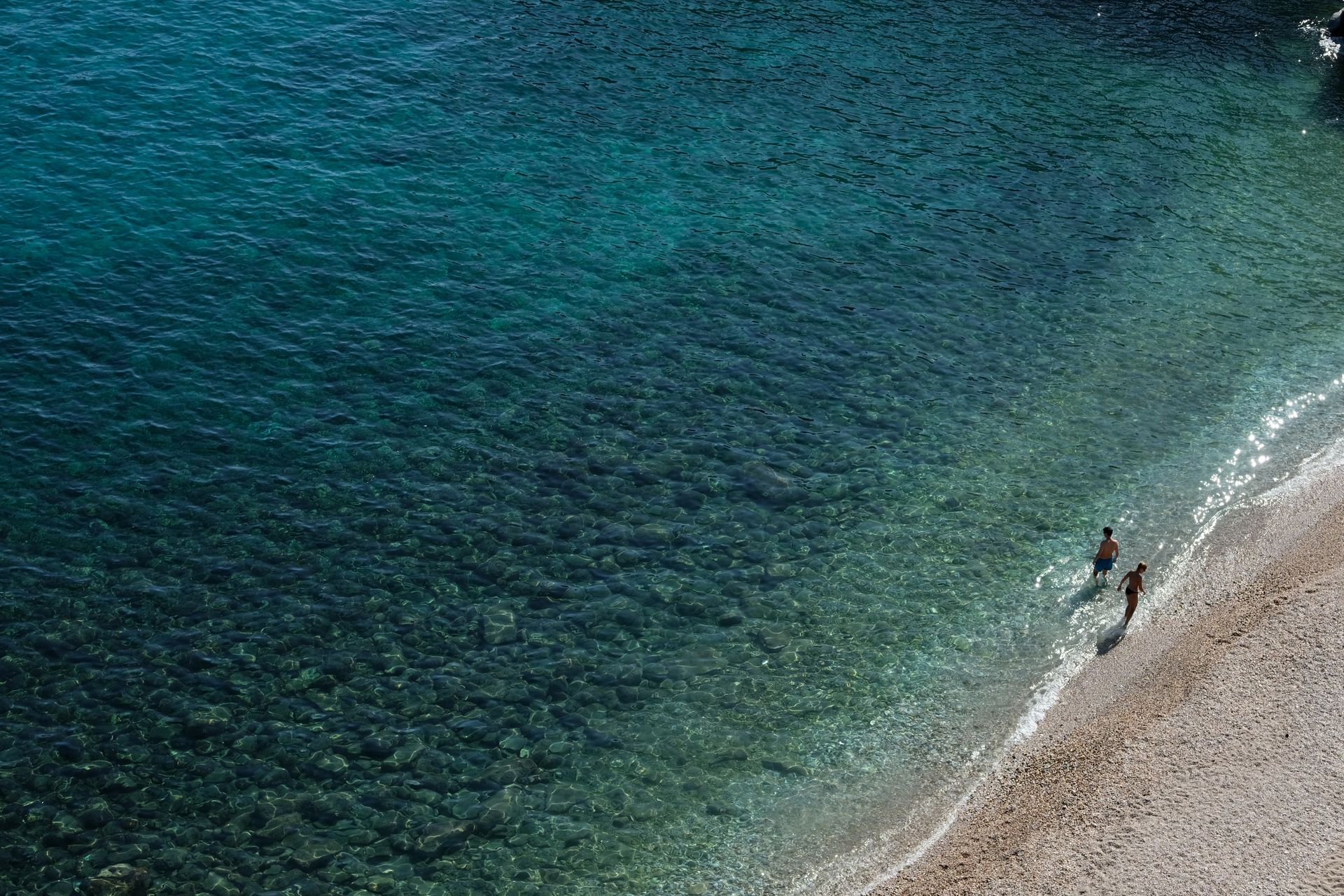 Clear turquoise waters and sandy shore at a beach on Thasos island Greece