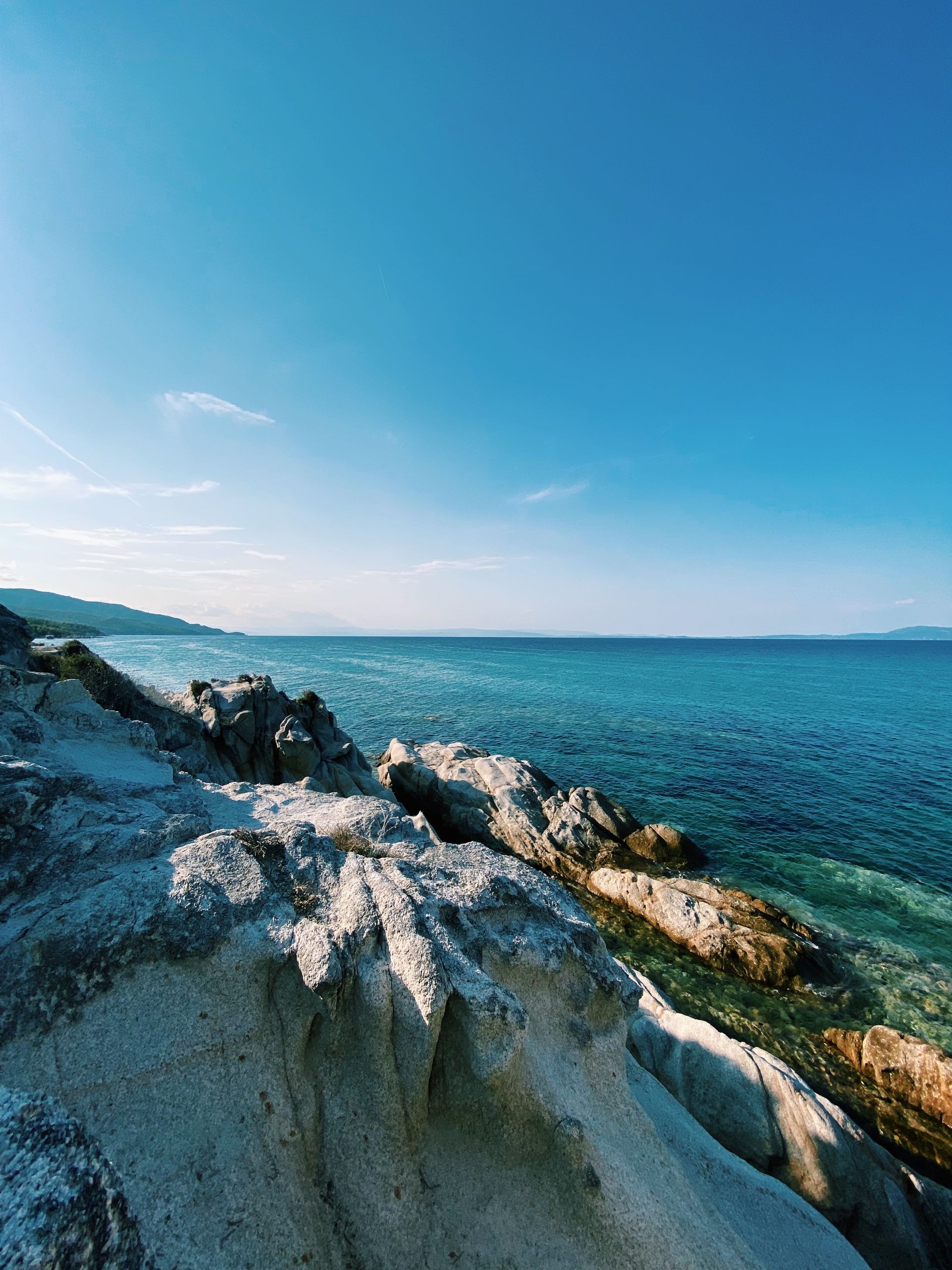 Rocky coastline with clear sea waters along the shore of Thasos island in northern Greece
