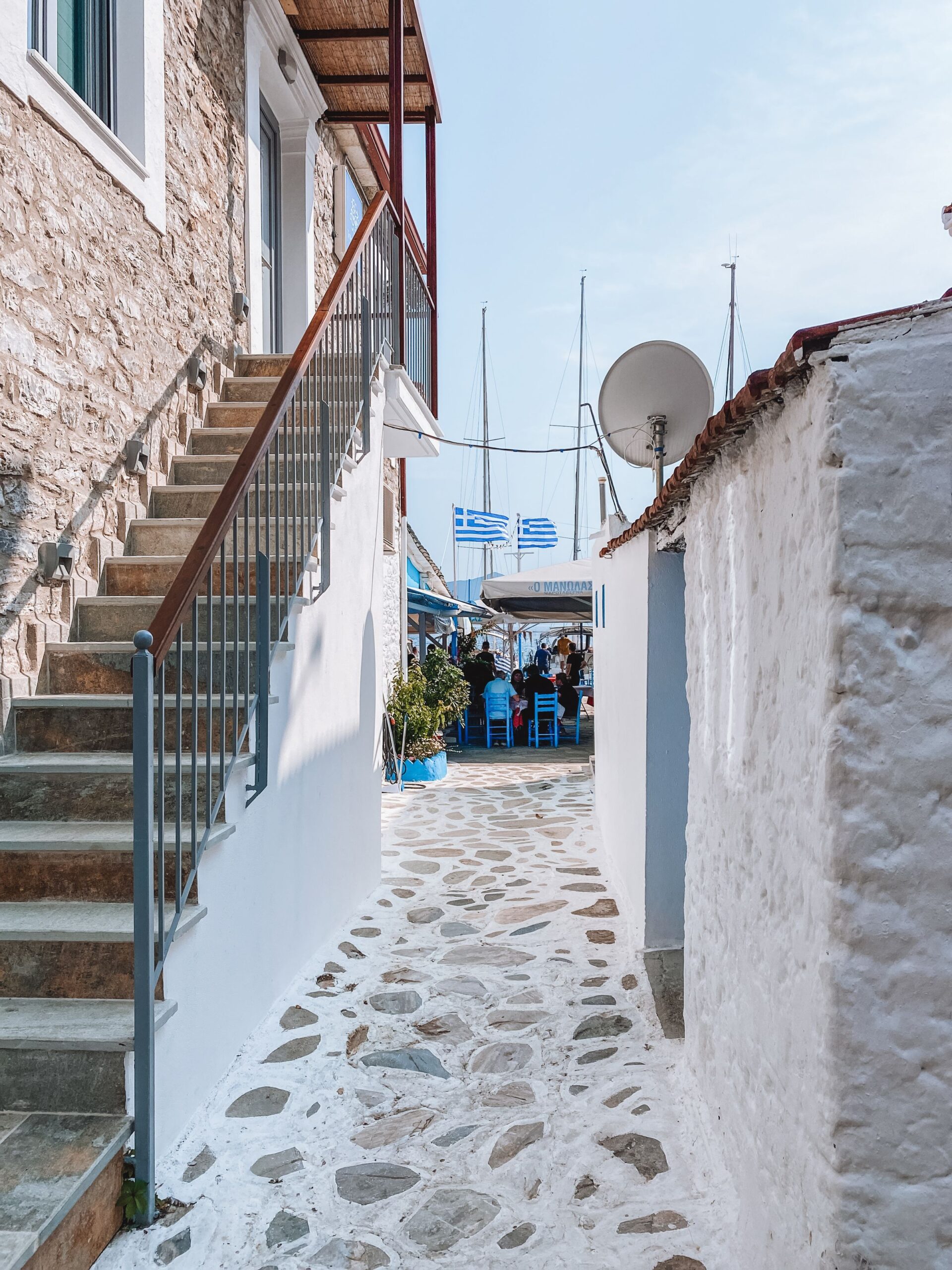 Narrow alley in Trikeri village at the southern tip of Pelion leading toward a view of the sea