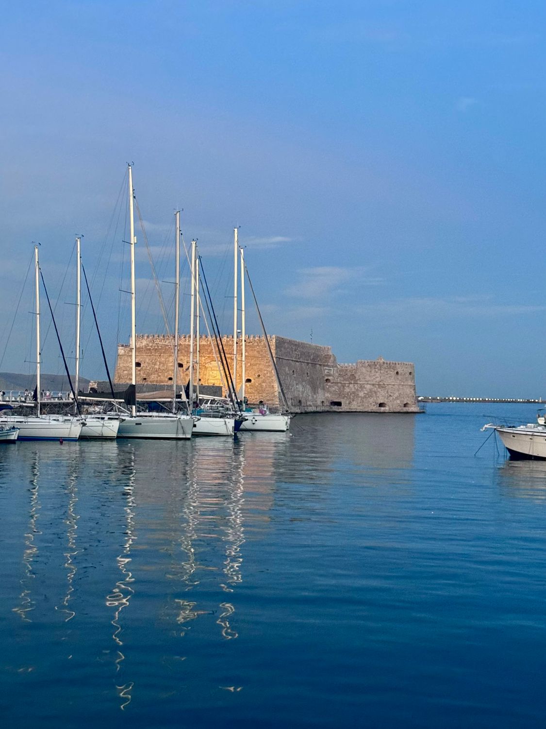 Yachts moored in the Venetian harbour of Heraklion with Koules Fortress in the background