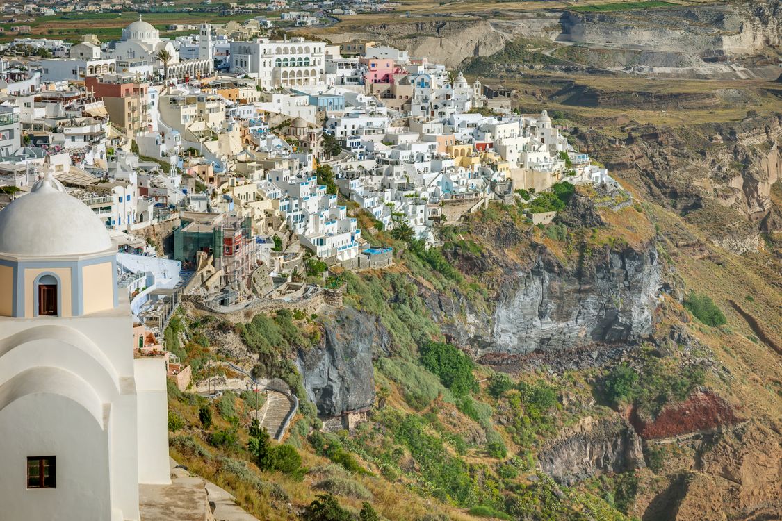 Panoramic view of Fira town perched on the caldera cliffs of Santorini with the Aegean Sea beyond