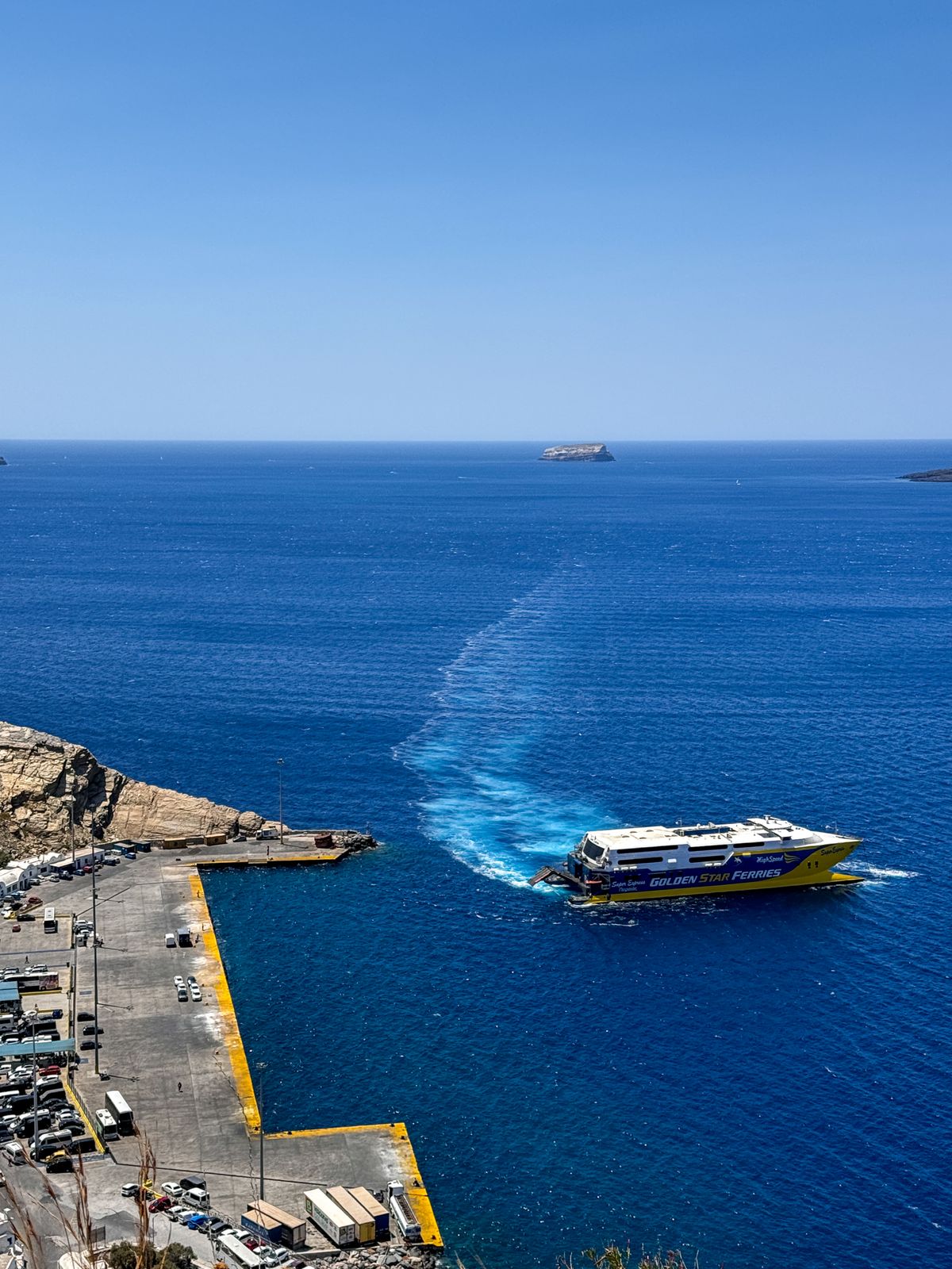 Blue Star Ferry leaving Fira harbour in Santorini with deep blue Aegean Sea