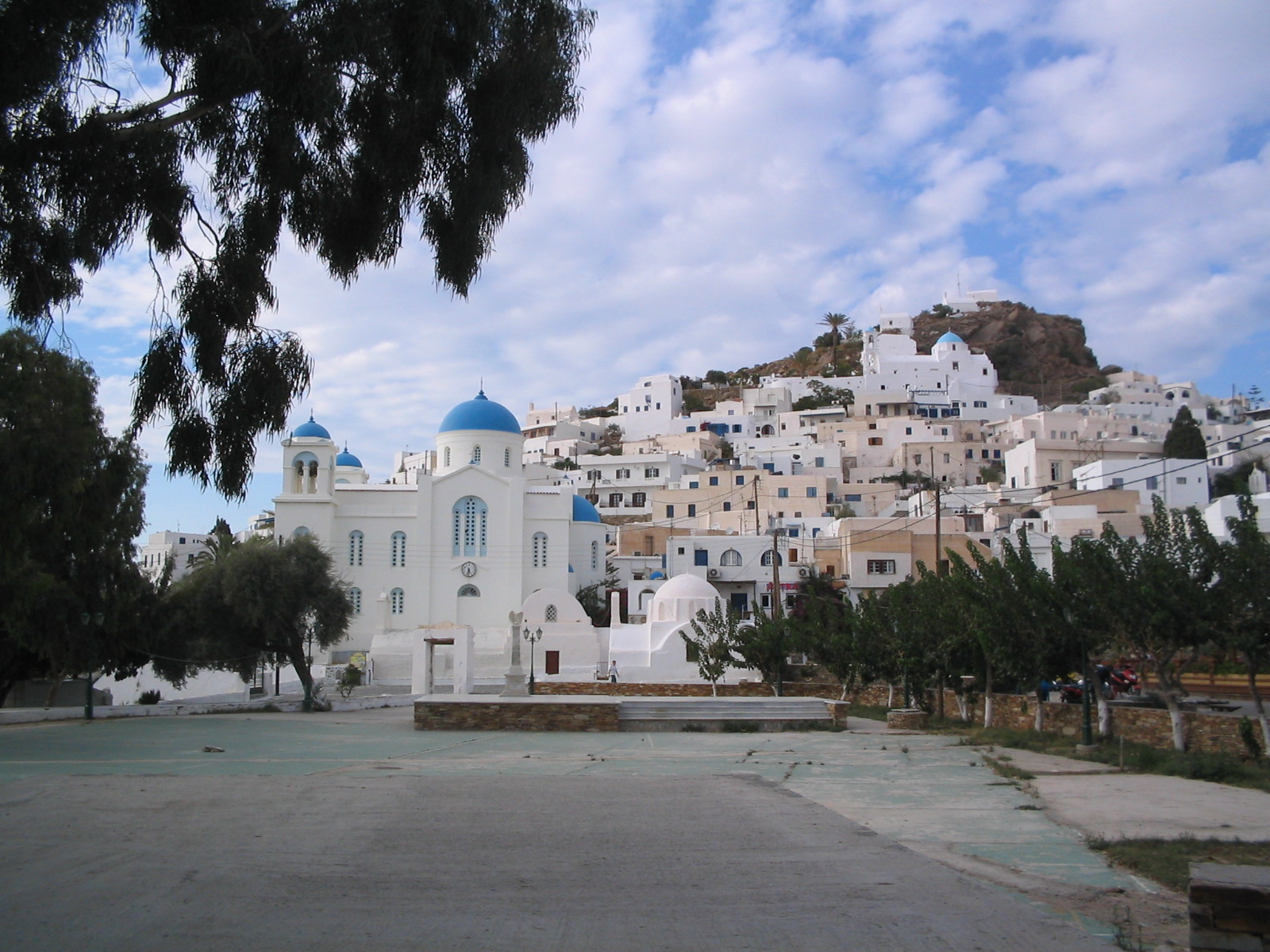 Overview of Ios village with white cubic houses and blue-domed churches in the Cyclades