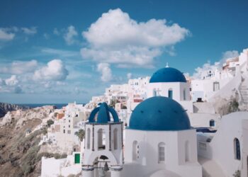Blue-domed churches and whitewashed buildings overlooking the caldera in Oia, Santorini