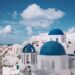 Blue-domed churches and whitewashed buildings overlooking the caldera in Oia, Santorini