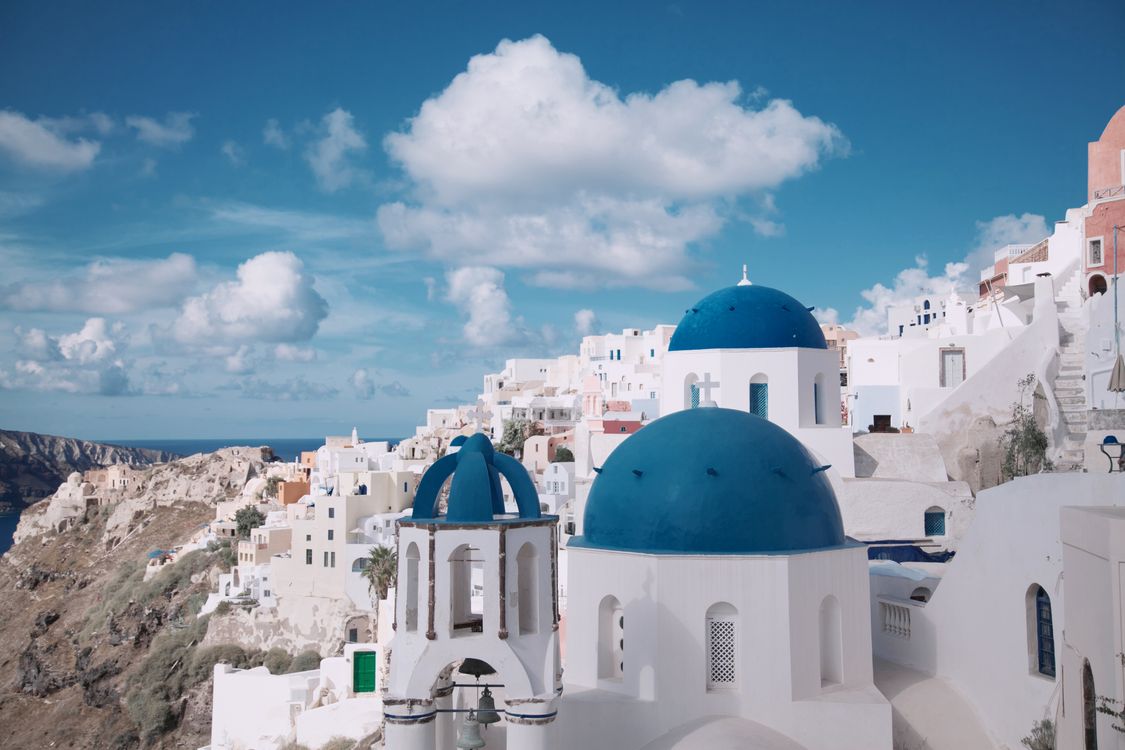 Blue-domed churches and white buildings in Oia village overlooking the Santorini caldera