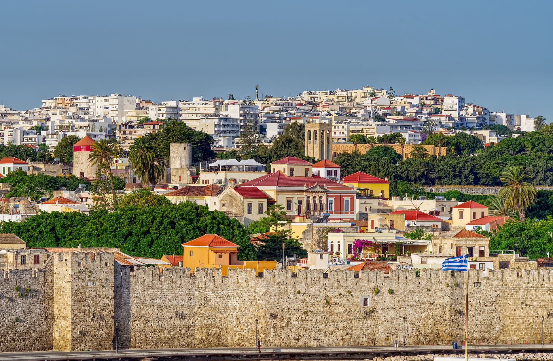 Rhodes Old Town colourful buildings and medieval walls under blue sky